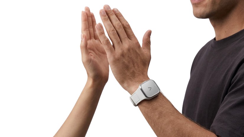 Two people high-five; one wears the Varuna wristband